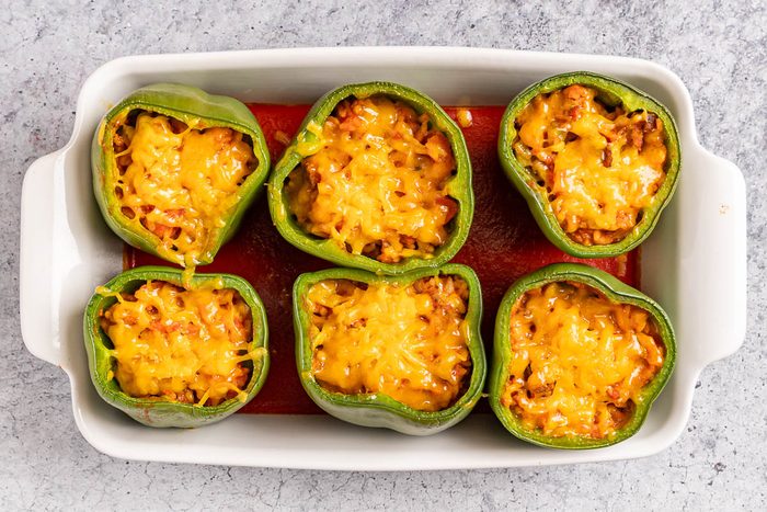 Taste of Home Meatloaf Stuffed Peppers photo of the baked peppers topped with cheese.