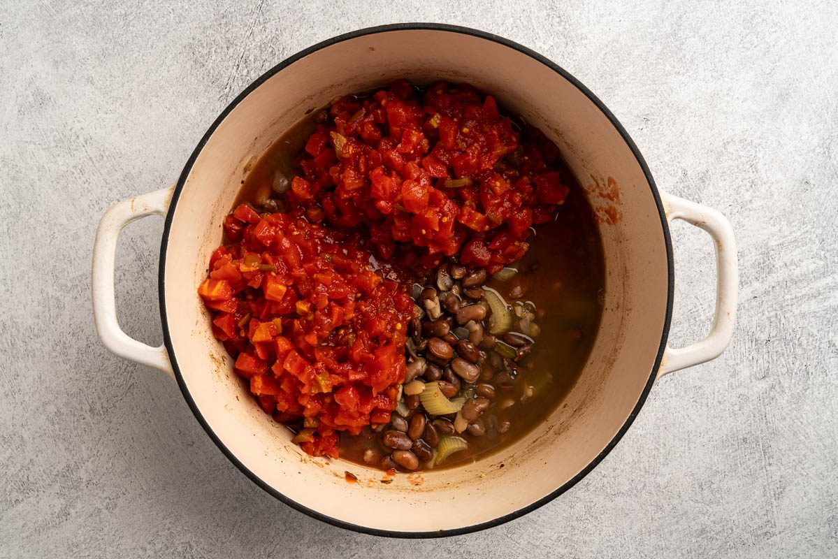 tomatoes added to the cooked pinto beans.