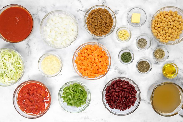 Vegetables, Olive oil and butter, Broth, Tomato sauce, Beans, Herbs, pepper, pasta and cheese in bowls