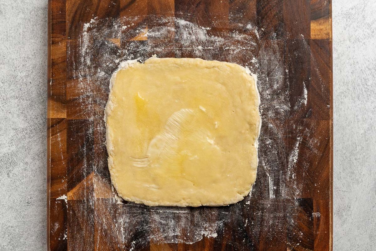 dough rolled out into a square and brushed with butter.
