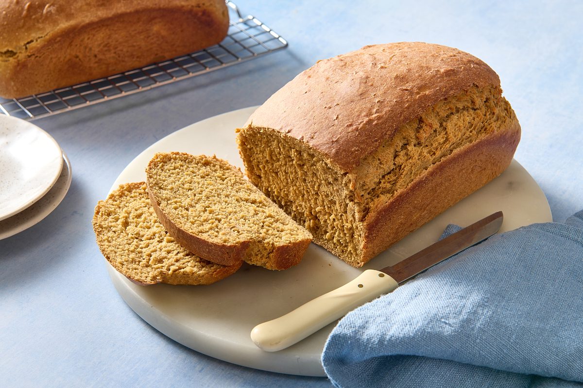 Oatmeal bread on a marble patter after being sliced, ready for serving