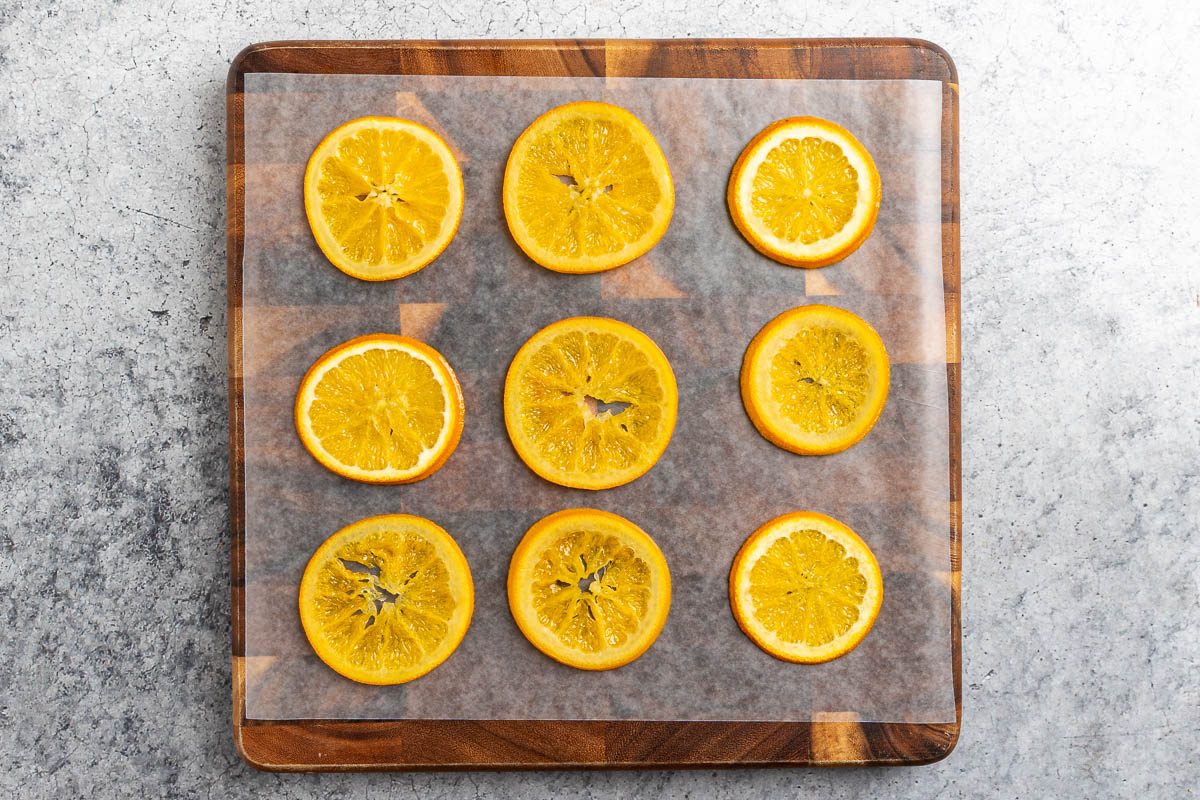 candied orange slices drying on waxed paper.