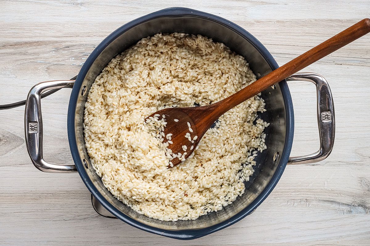 Stirring wine into the arborio rice for Parmesan risotto.