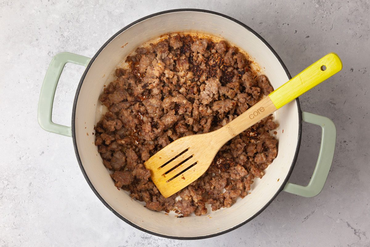 Step 2 of Taste of Home Pasta with Sausage & Peas is to brown the sausage and the garlic