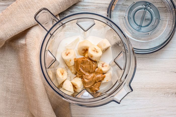 Peanut butter smoothie preparation in the blender.