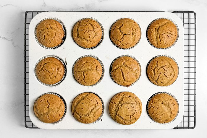 Taste of Home Peanut Butter Cupcakes in a muffin tin on a wire rack