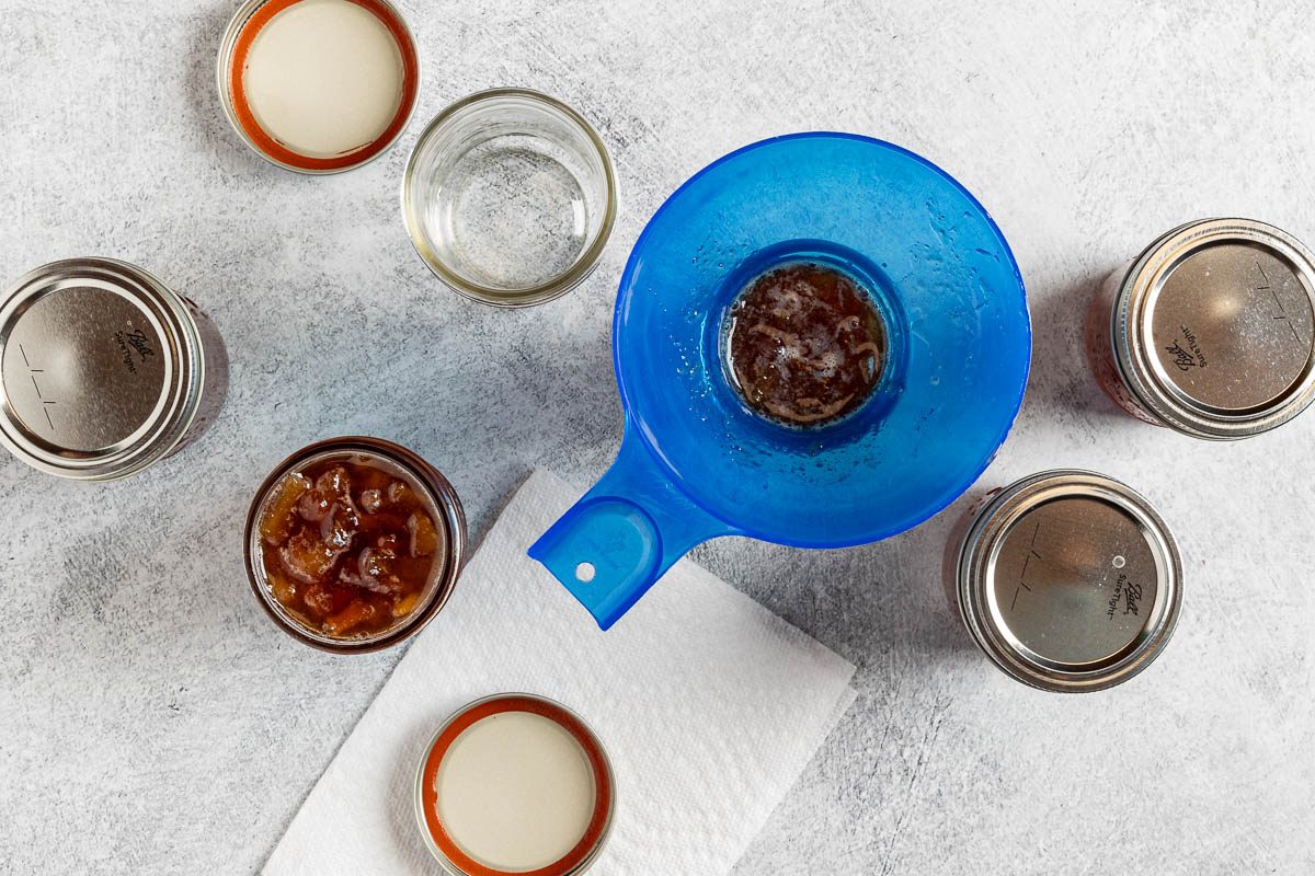 adding the jam to jars.