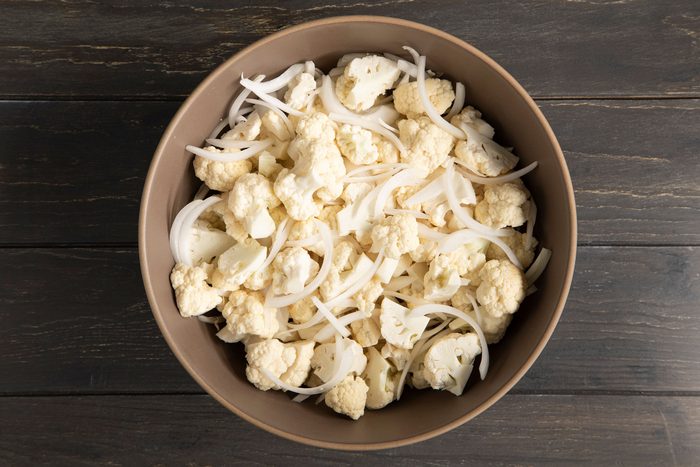 A bowl of cut cauliflower and onions