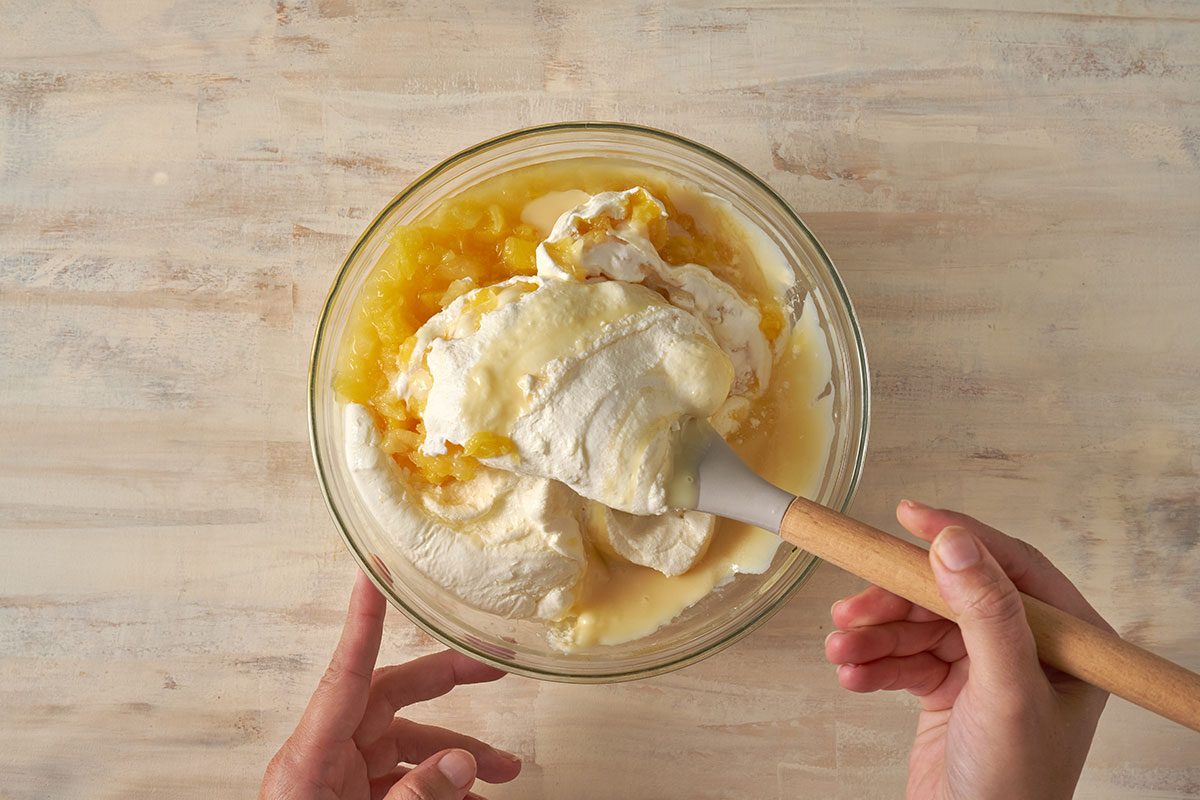 Mix condensed milk, crushed pineapple, and lemon juice, then fold in the whipped topping to create a creamy and tropical filling for Pineapple Pie, by Taste of Home