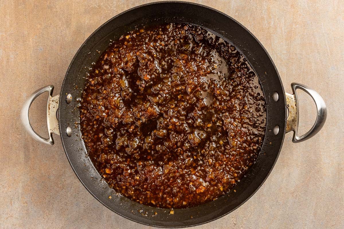 making sauce in a skillet for Pineapple Pork Chops 