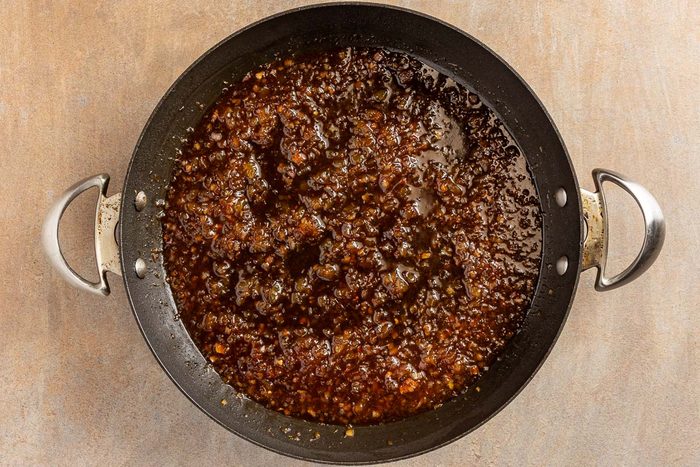 making sauce in a skillet for Pineapple Pork Chops