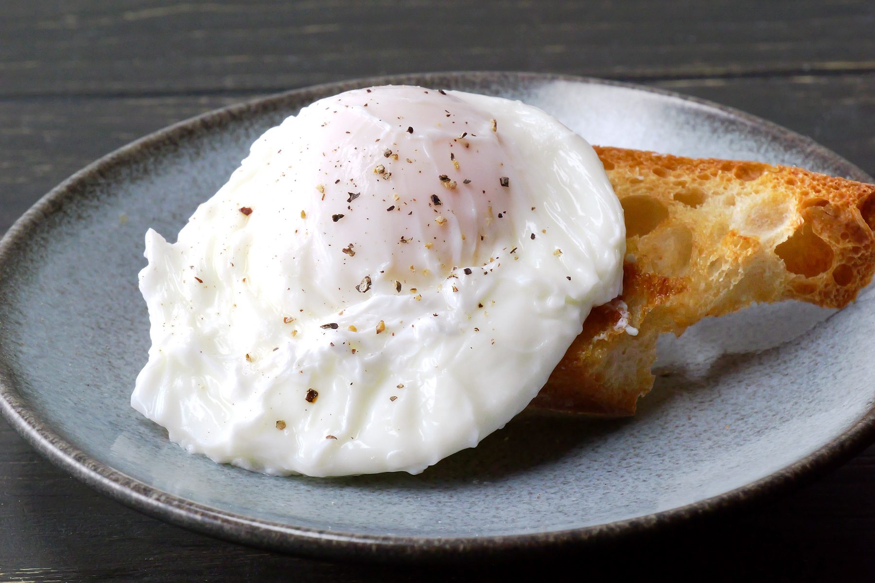 Close shot of poached eggs, showcasing their soft, runny yolks.