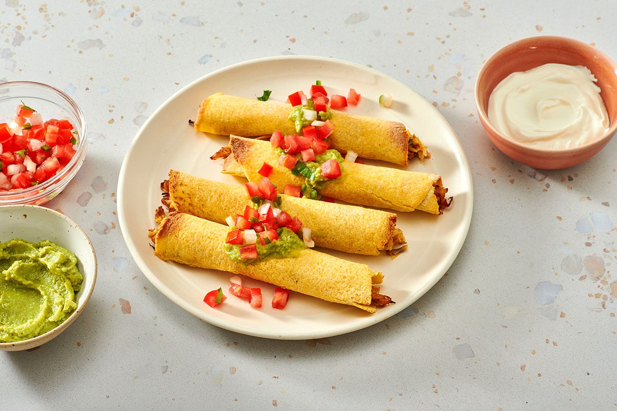 Taquitos served with guacamole pico de gallo and sour cream.