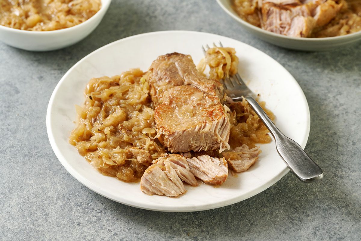 Close-up horizontal shot of the Taste of Home Pork and Sauerkraut, highlighting the tender pork ribs and the texture of the sauerkraut.