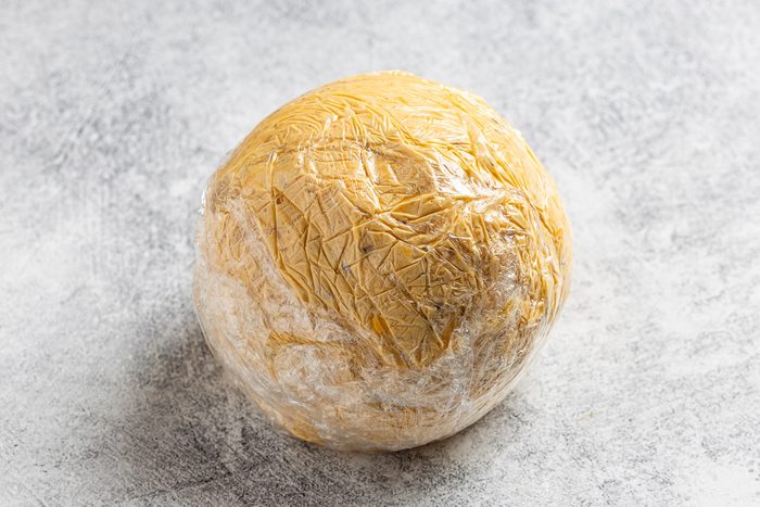 Taste of Home Pumpkin Cheese Ball photo of all the ingredients mixed together, formed into a ball and wrapped in plastice wrap.