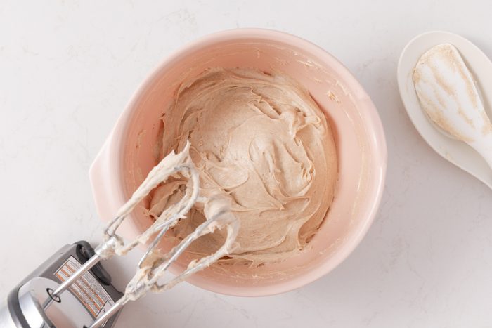 Frosting for pumpkin cupcakes being mixed in.