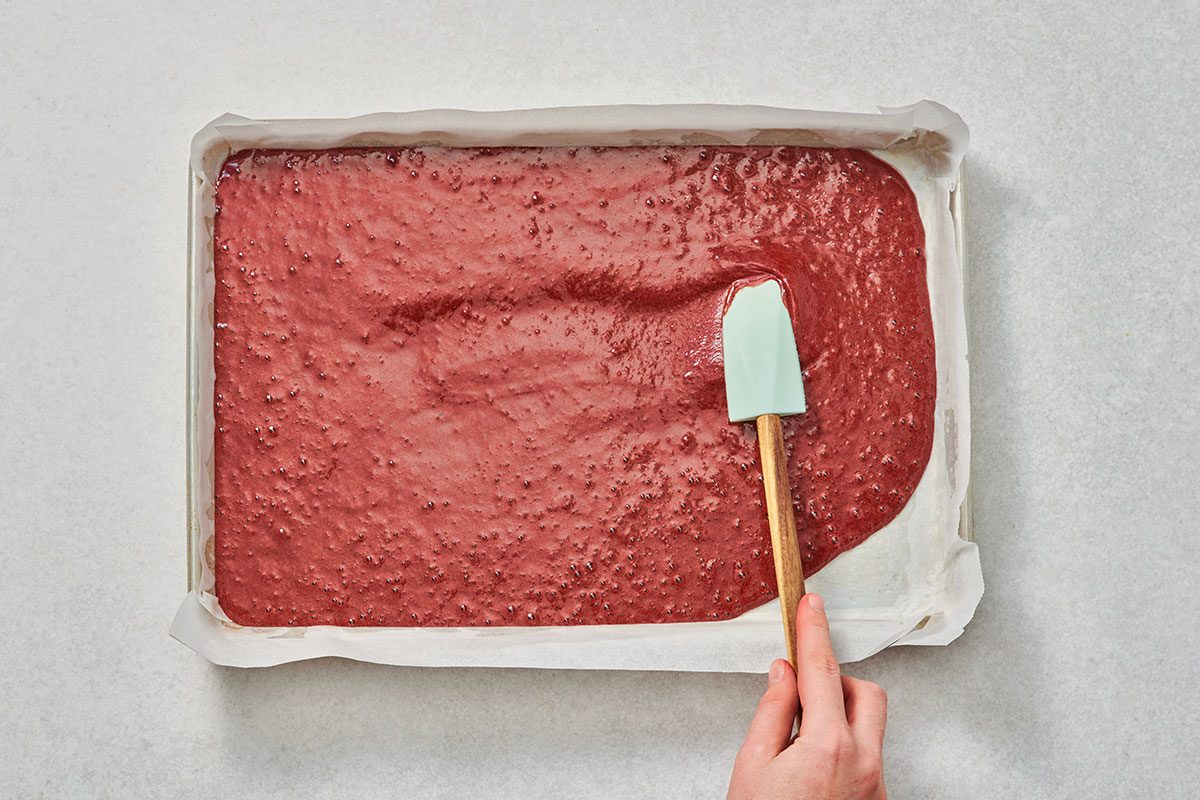 Spreading red velvet cake batter in a pan