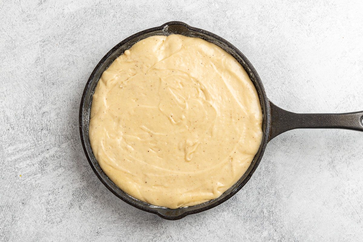 cake batter poured into the cast iron skillet.