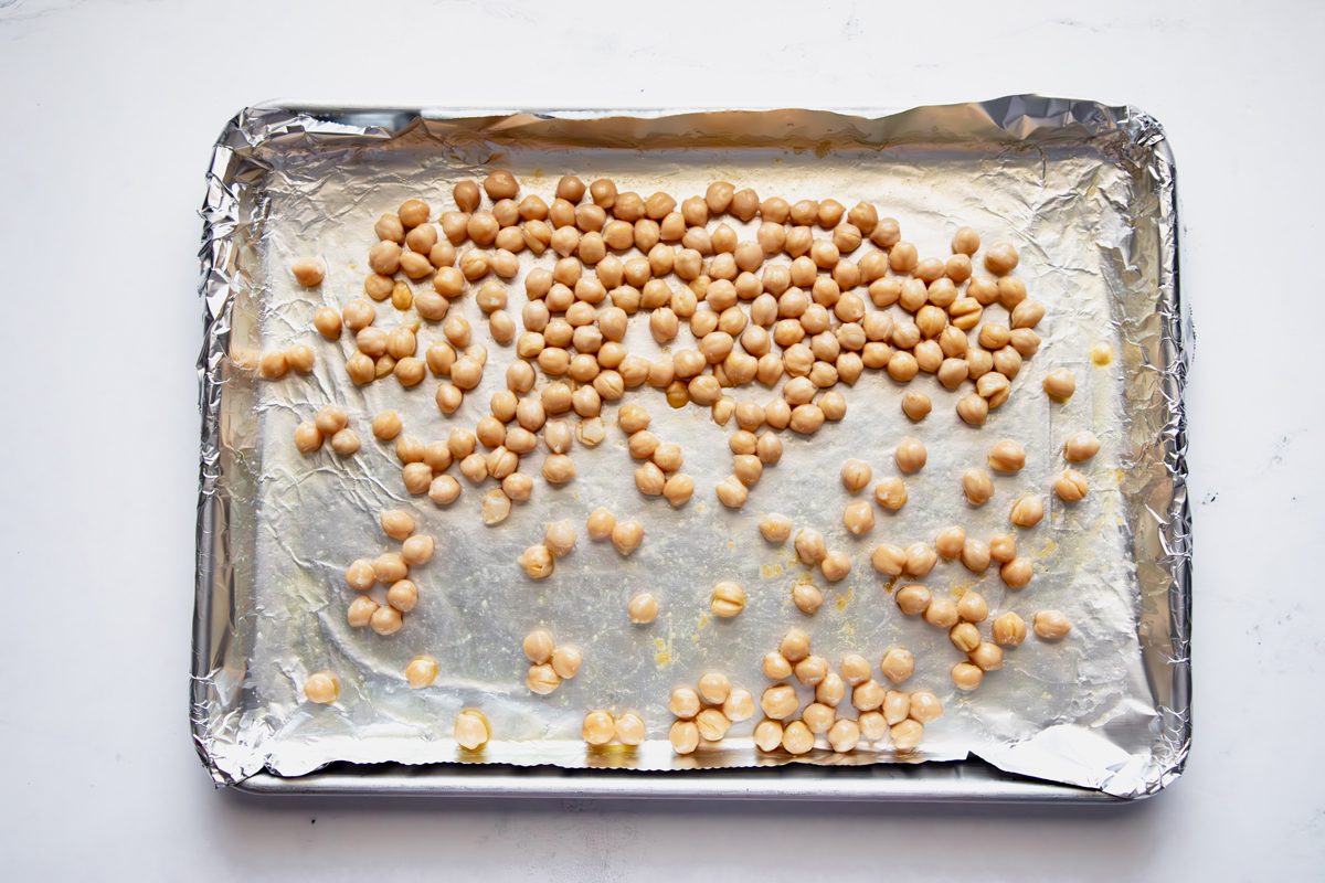 Overhead shot for Taste of Home Roasted Chickpea Salad with chickpeas on a prepared baking sheet.