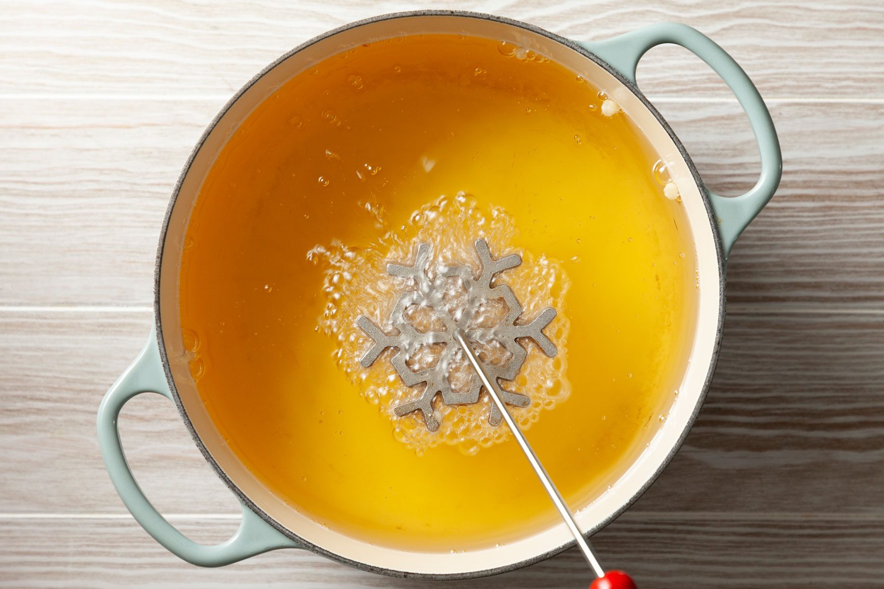 Battered iron placed in hot oil.