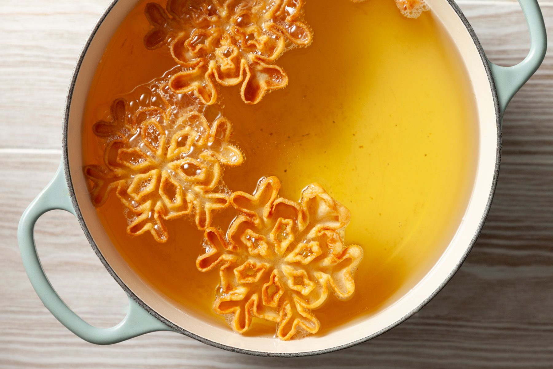 Rosettes being fried in oil.