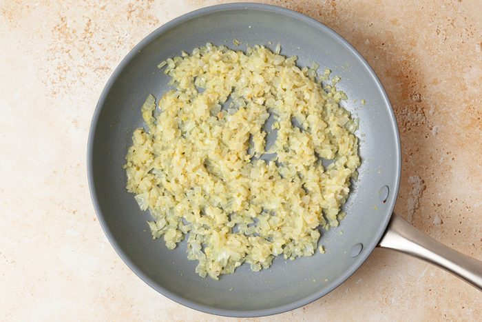 Step 1 of Taste of Home Slow-Cooked Italian Meatballs is to cook the onions and garlic