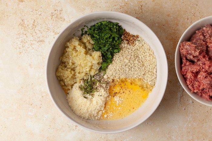 Step 2 of Taste of Home Slow-Cooked Italian Meatballs is to combine the remaining meatball ingredients