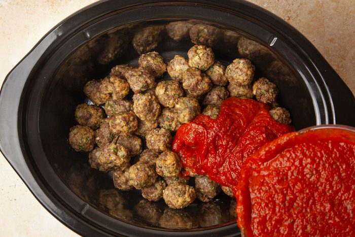 Step 4 of Taste of Home Slow-Cooked Italian Meatballs is to transfer to slow cooker and add the sauce
