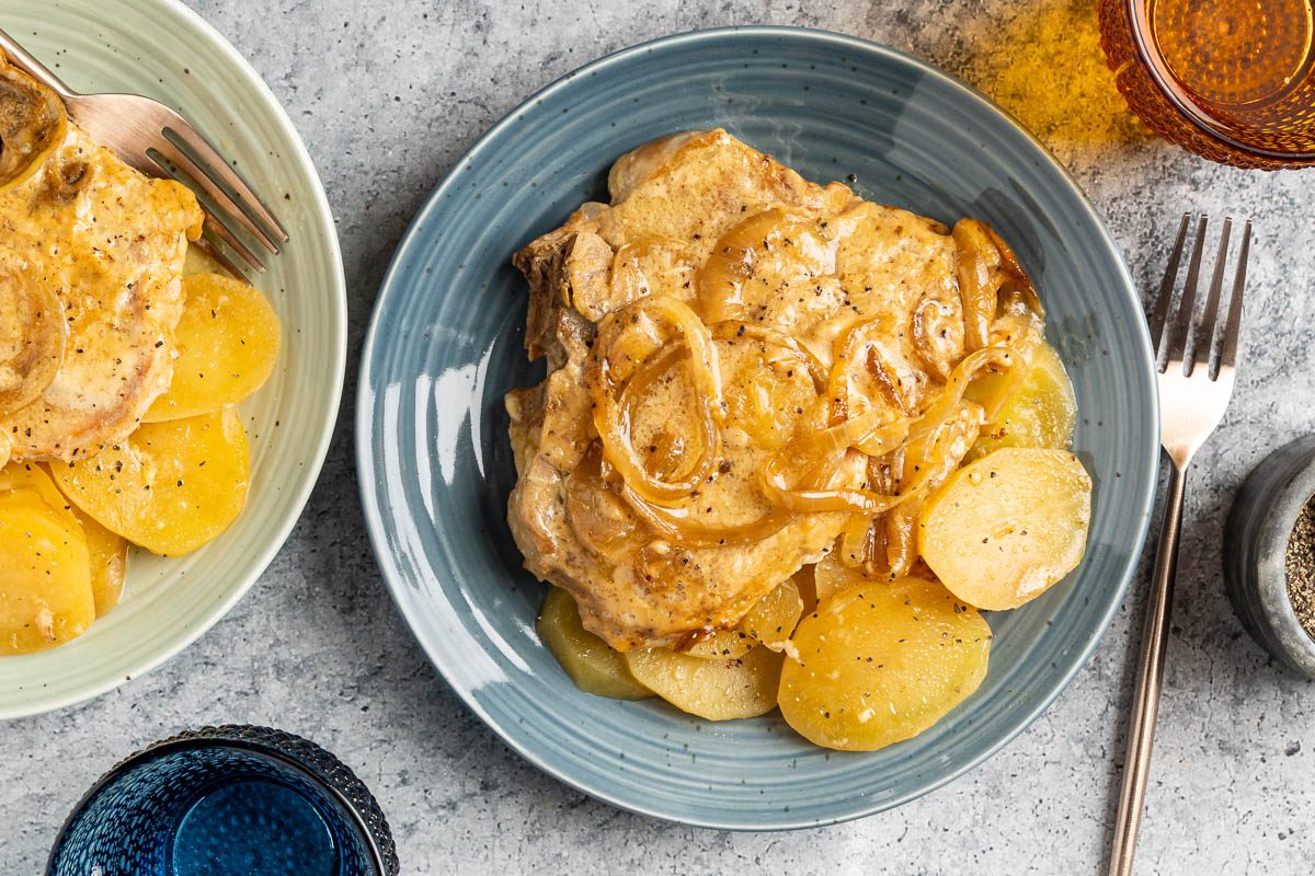 Taste of Home Slow Cooker Pork Chops and Potatoes photo of the finished recipe served on plates.