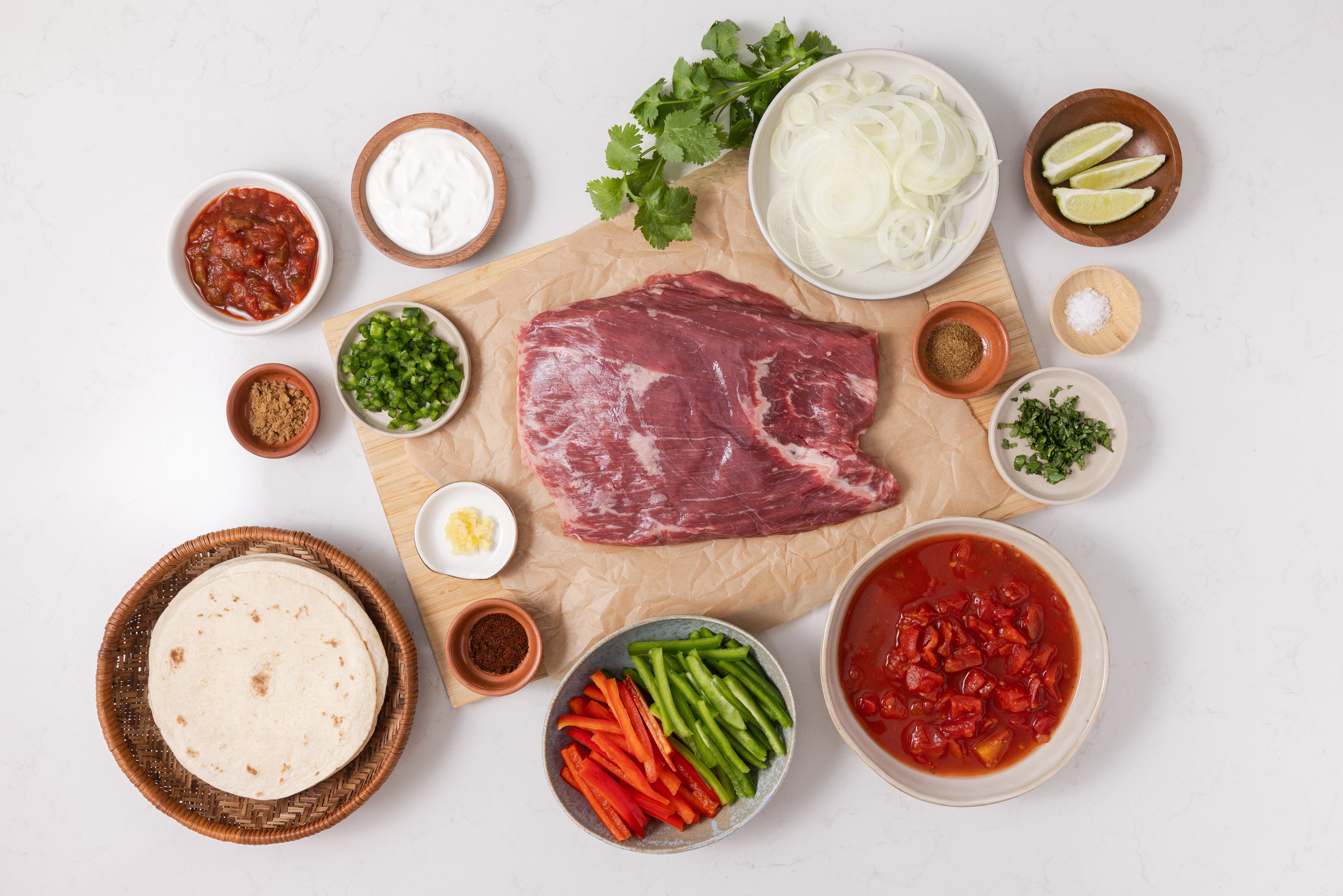 Ingredients for slow cooker steak fajitas on kitchen counter.