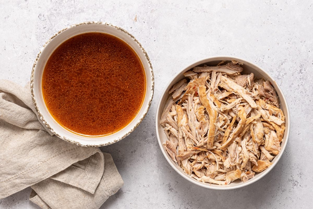 Cooking Juices And Shredded Chicken In Bowls