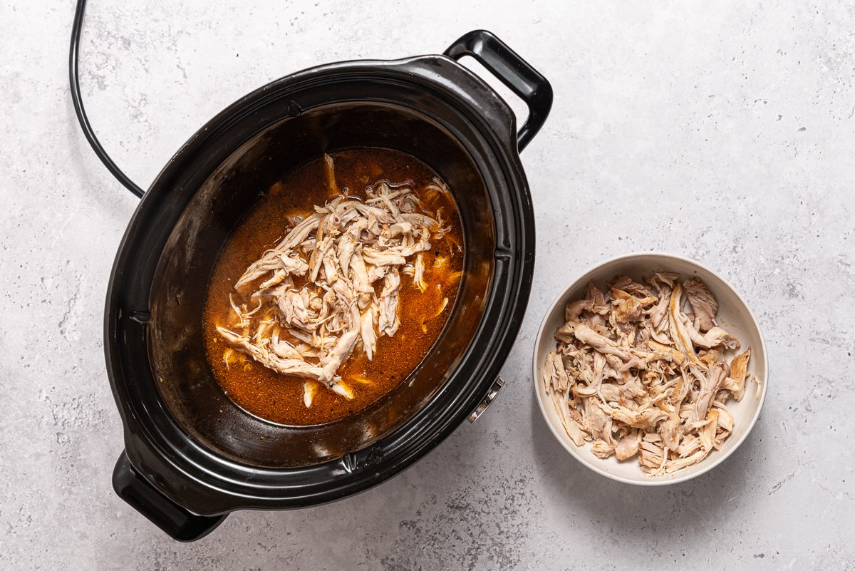 Shredded Chicken And Cooking Juices Inside Crocopot