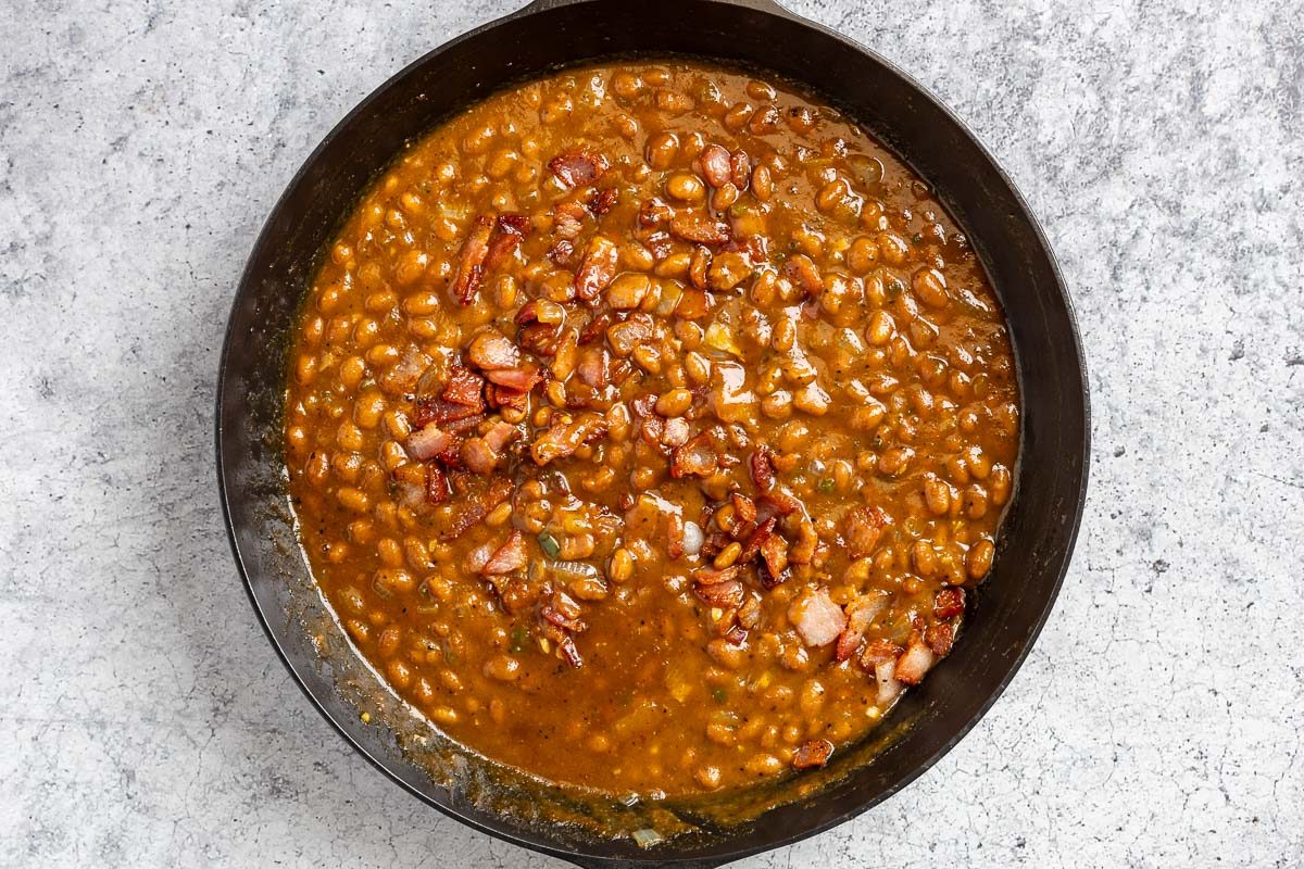 Taste of Home Smoked Baked Beans photo of all the ingredients simmered in the cast iron skillet.