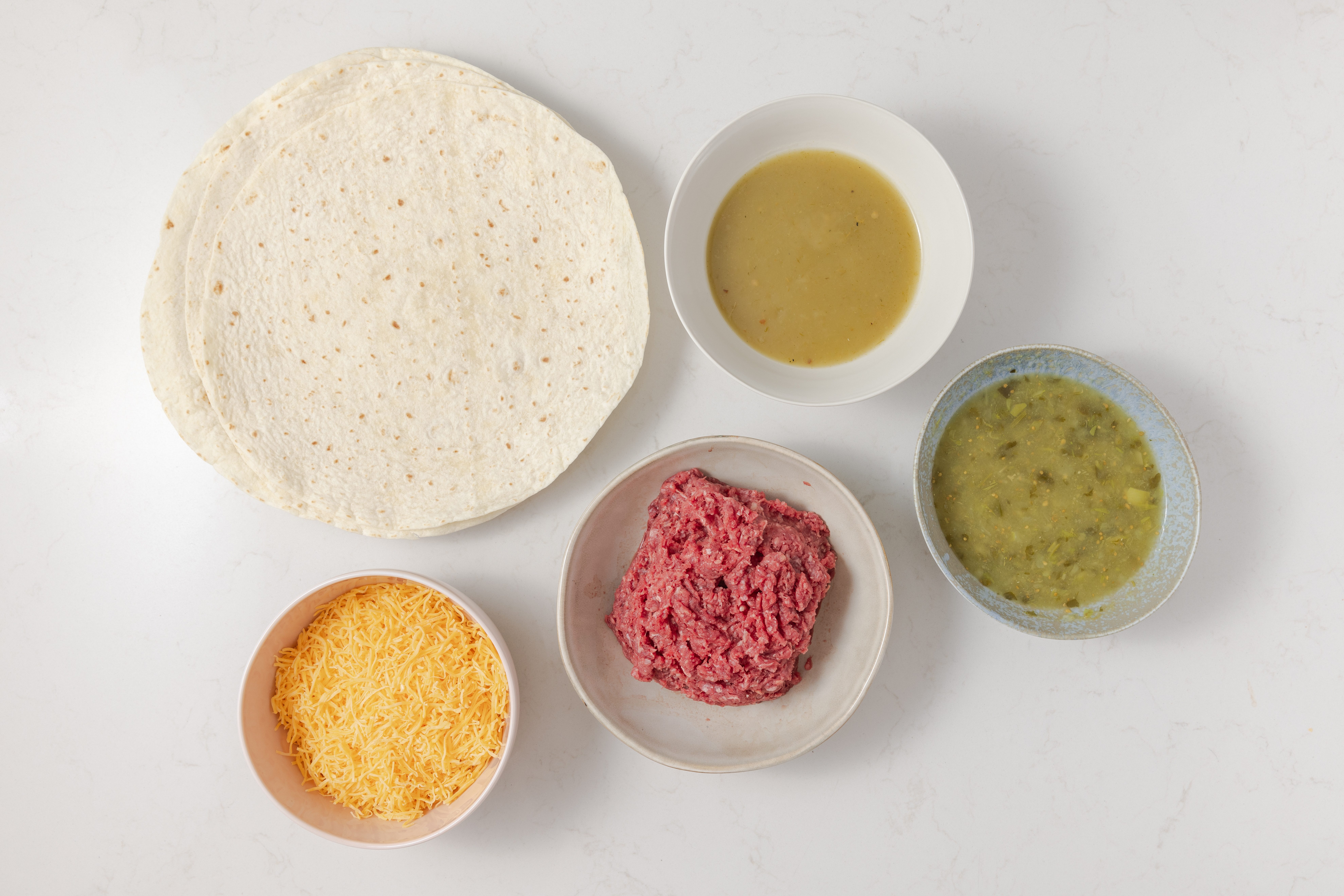 Ingredients for smothered burrito on kitchen counter.