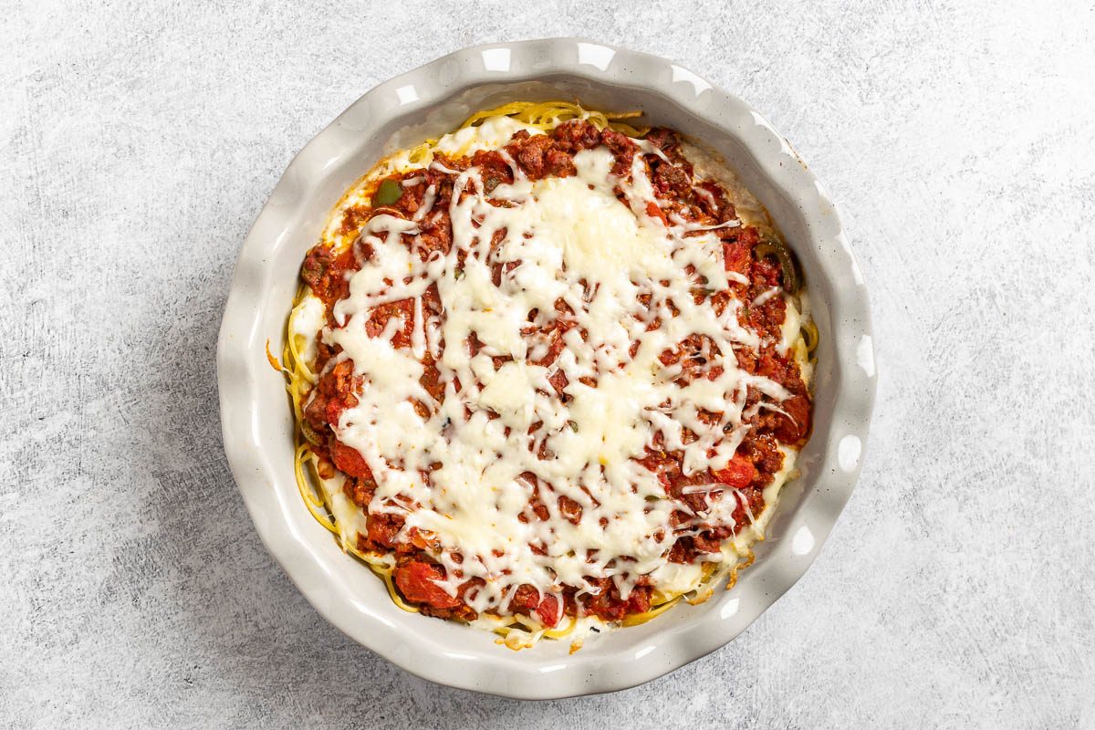 Taste of Home Spaghetti Pie photo of the baked pie topped with mozzarella cheese.