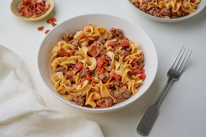 Close-up of Taste of Home's Spanish Noodles recipe, served with egg noodles, beef, and bacon