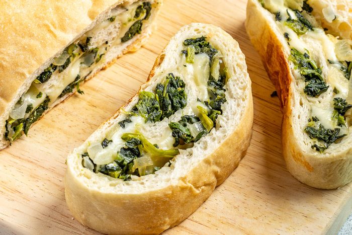 Taste of Home Spinach Bread photo of the finished recipe sliced and served on plates.