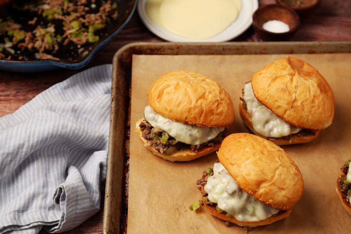 Close up of Taste of Home's Philly Cheesesteak Sloppy Joes on a wooden surface.