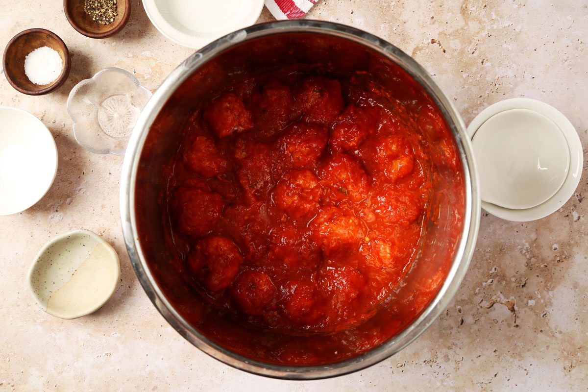 Process of making Taste of Home's Instant Pot Meatballs in an instant pot on a brown marble surface.