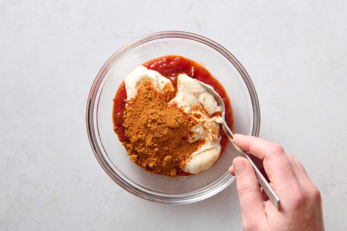 Combining sauce ingredients in a small bowl