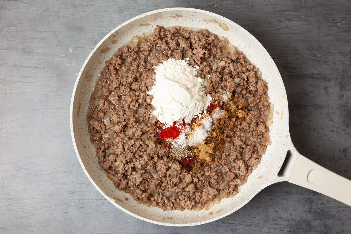 Step 3 of Taste of Home Cowboy Stew is to add the seasonings and flour