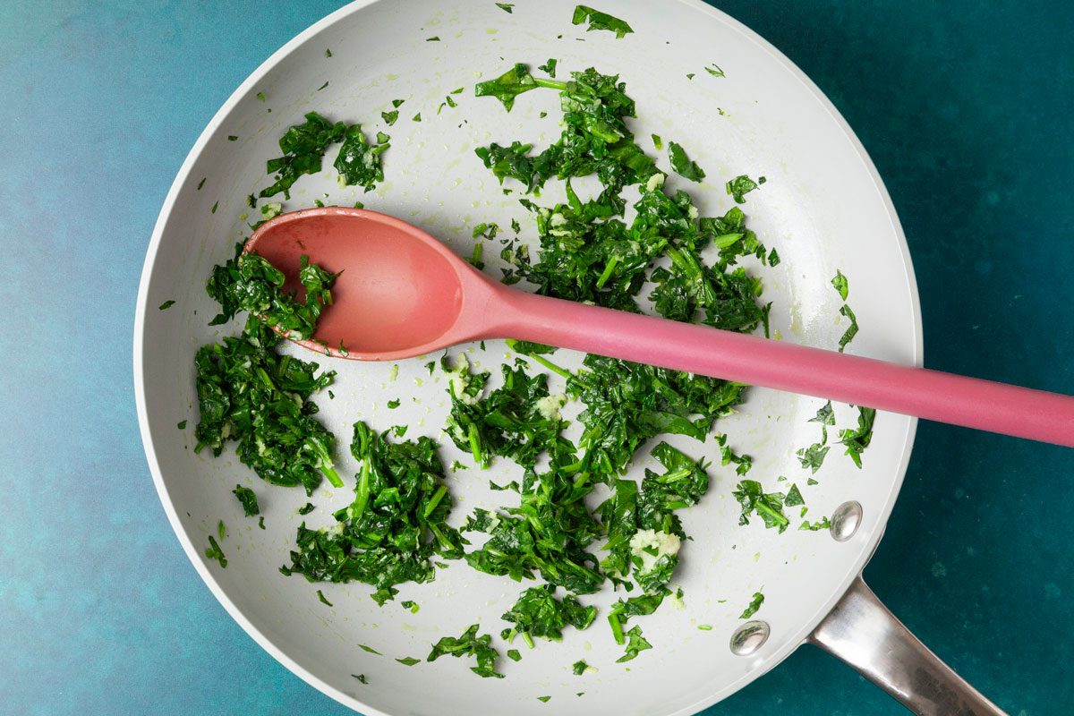 Step 1 of Taste of Home Turkey Feta Meatballs is to Heat olive oil in a small skillet over medium-low heat. Add the chopped spinach and garlic, cooking until the spinach wilts and the garlic becomes fragrant, about one to two minutes. Remove from heat and set aside to cool slightly.