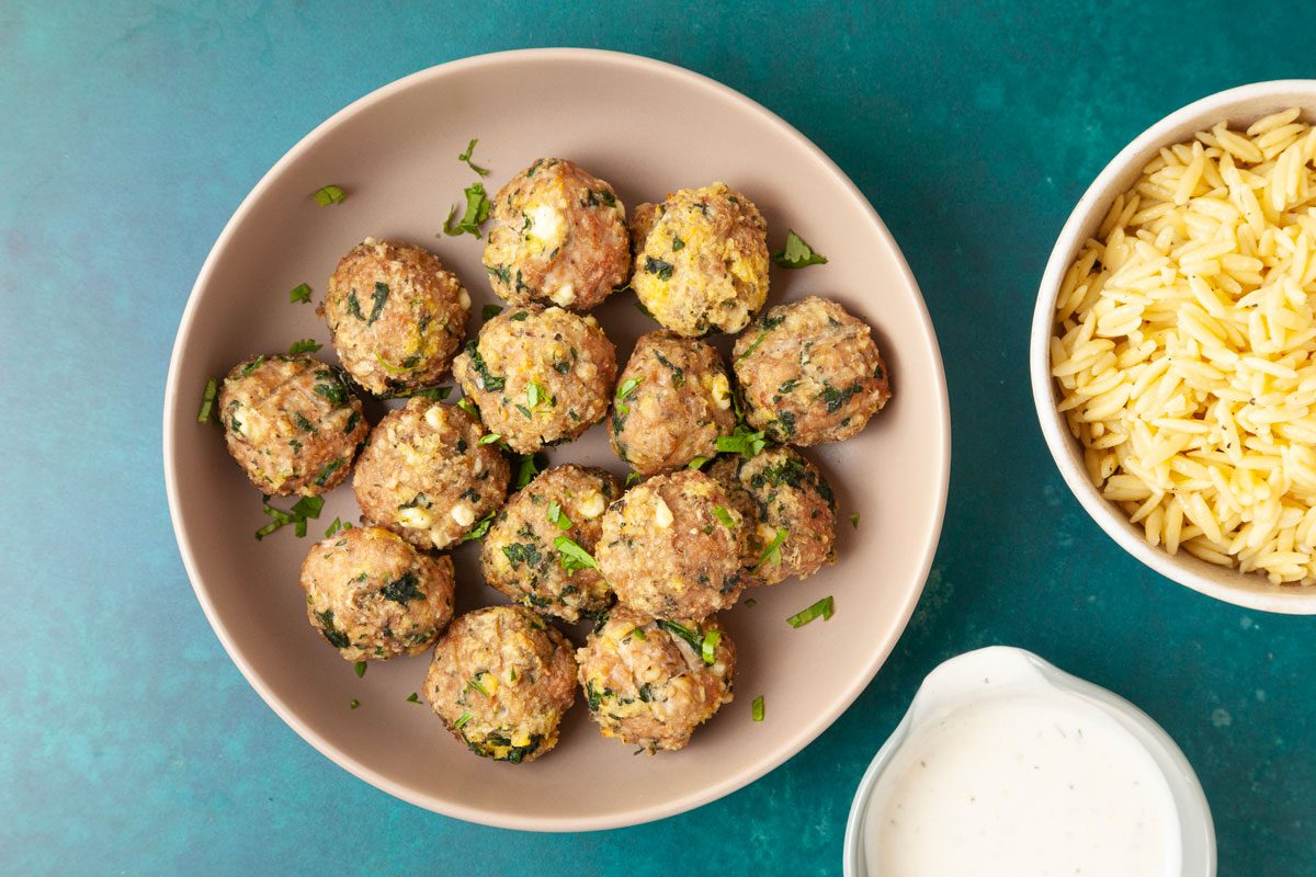 Full yield of Taste of Home Turkey Feta Meatballs, side of orzo, yogurt sauce