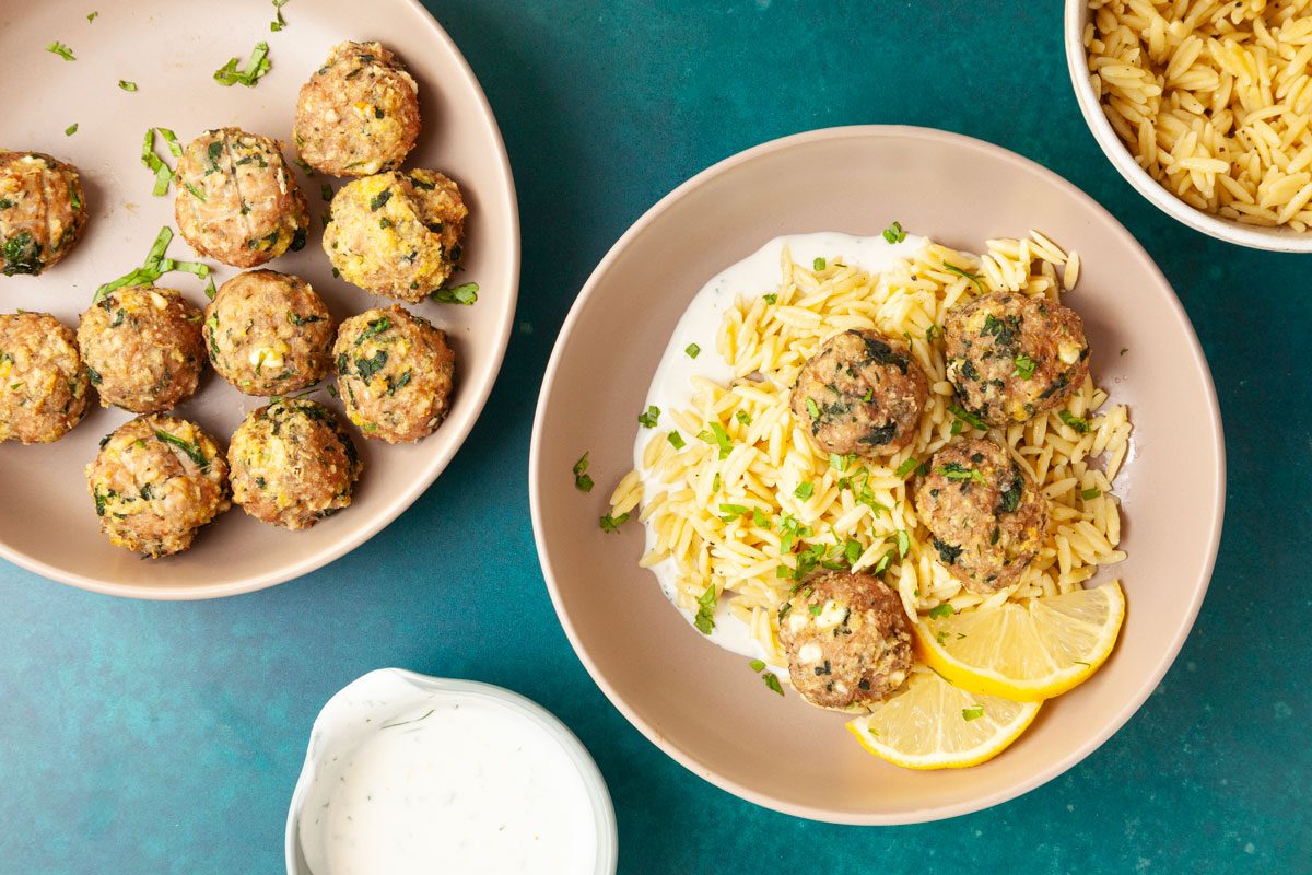 Full yield of Taste of Home Turkey Feta Meatballs, side of orzo, yogurt sauce