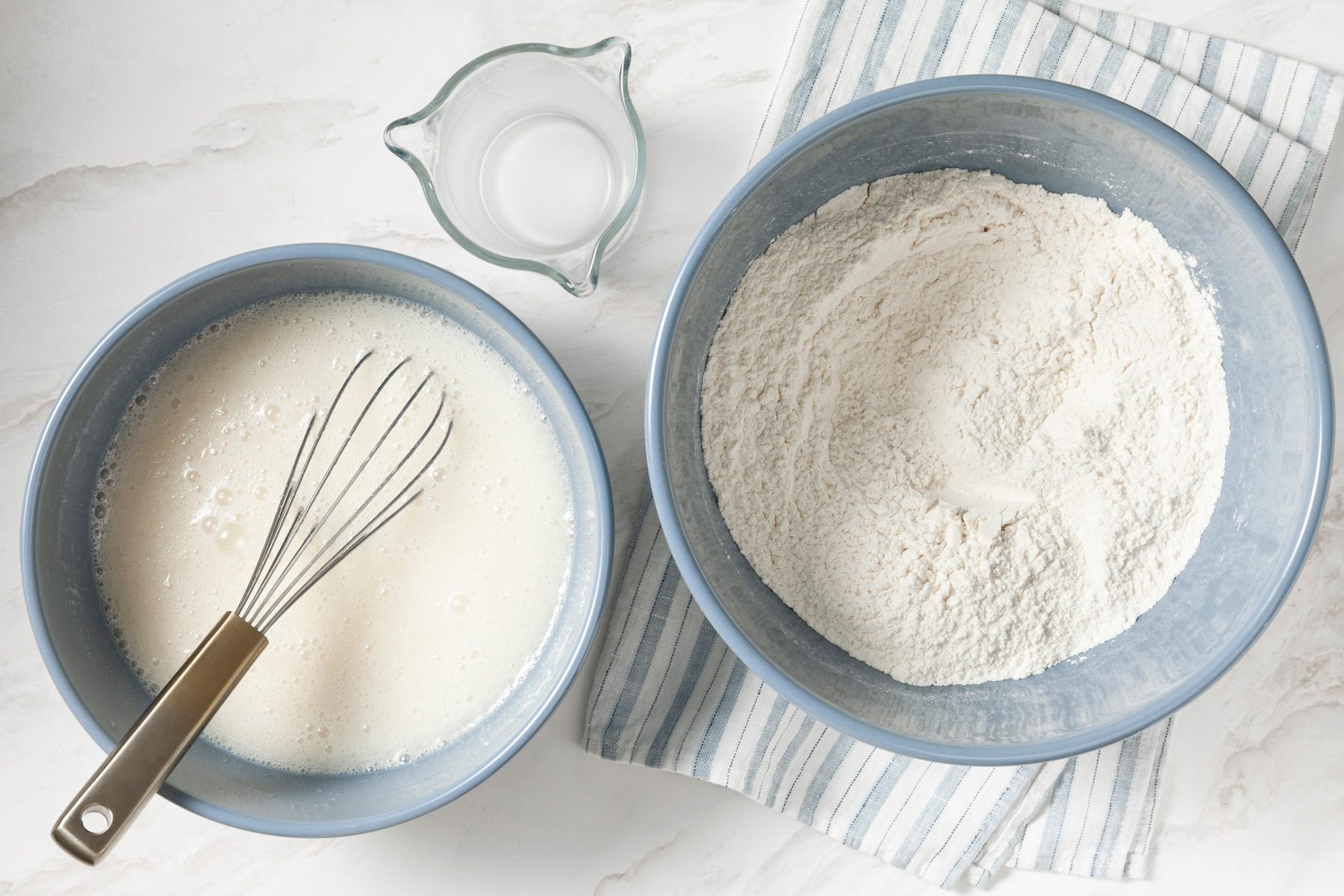 Bowls containing flour, baking powder, baking soda and salt.