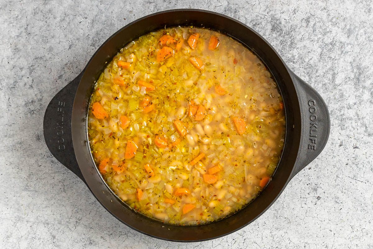 Taste of Home White Bean and Kale soup photo of cooking the aromatics, spices, and beans.