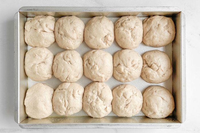Proofed Taste of Home Whole Wheat Rolls in a metal baking pan