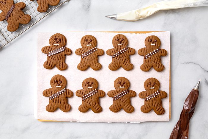 Decorated wookie cookies with chocolate eyes, noses and belts, with white chocolate mouths and bullets for step seven of Wookie Cookie recipe for Taste of Home