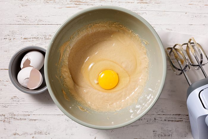 Add eggs, one at a time.