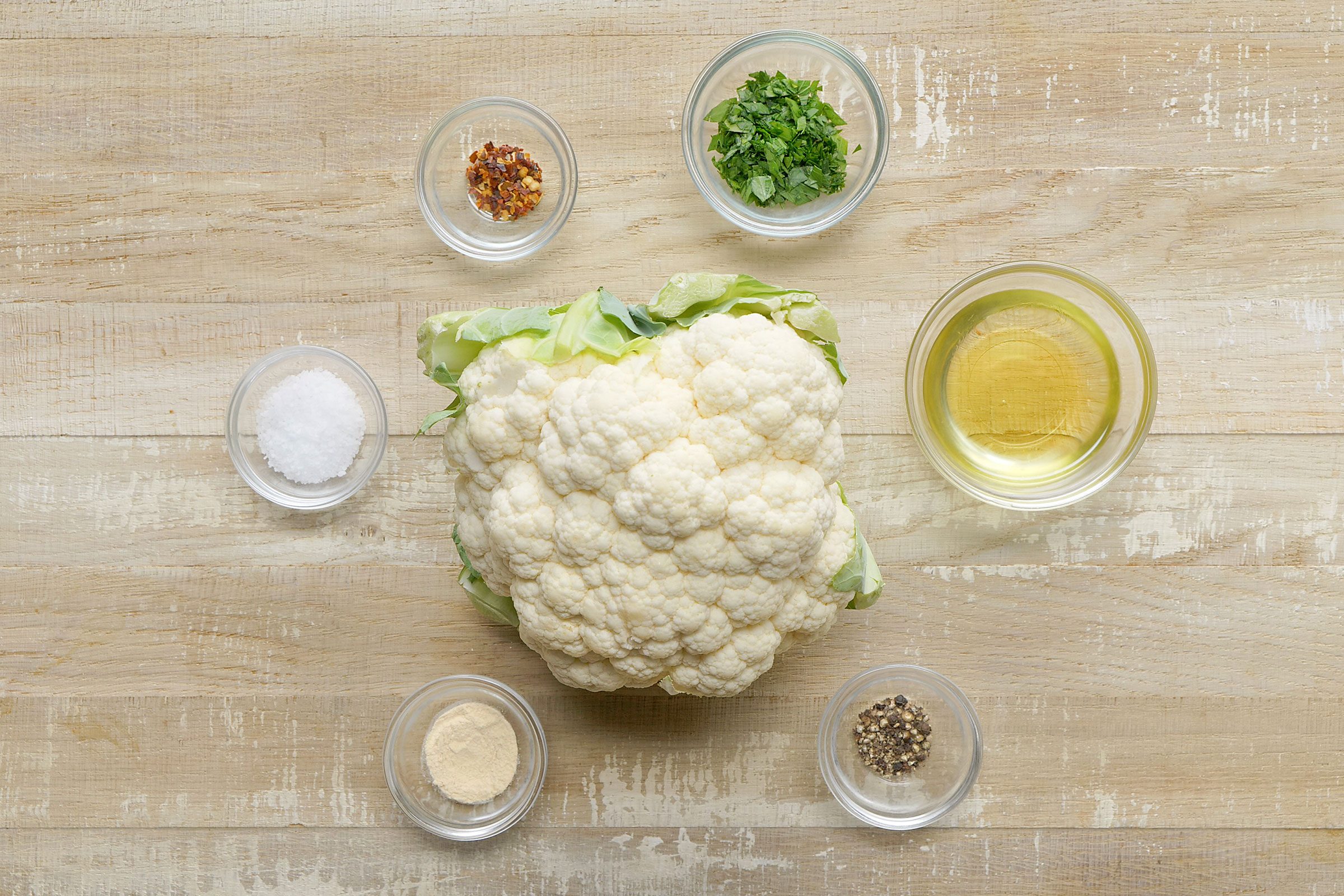 Cauliflower Steak ingredients with a cauliflower placed in center